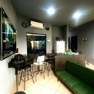 a living room with a green couch and a table at Casa con alberca en Morelos in Barranca Honda +13 photos