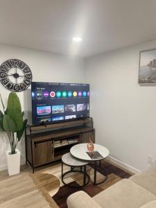 a living room with a tv and a coffee table at Cozy 2 Bedroom Suite Close to Amenities in Edmonton +24 photos