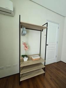 a room with a shelf with a plant in it at 1BR Condo w Pool & Balcony Near Robinson Place - F&M Homes - Sitio Uno Residences, Pueblo de Panay in Roxas City