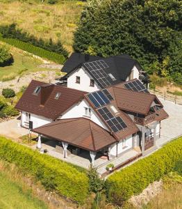 an aerial view of a house with solar panels on it at Dom w Chomranicach-domek grillowy in Chomranice