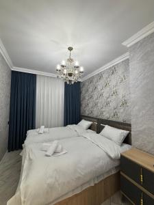 Ένα ή περισσότερα κρεβάτια σε δωμάτιο στο Smart Dom Apartments Baku +16 φωτογραφίες
