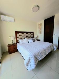 a bedroom with a large bed with a striped blanket at Hogar Tu Santuario Uruapan in Uruapan del Progreso
