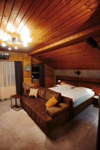 a bedroom with a large bed and a couch at Pepin Stay in Topoľčany