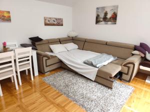 a living room with a couch and a table at Apartman NN Trebinje in Trebinje