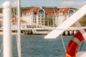 a view of a hotel from a boat in the water at Sheraton Sopot Hotel in Sopot