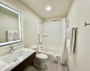 a white bathroom with a sink and a toilet at Alaska's Select Inn Wasilla in Wasilla