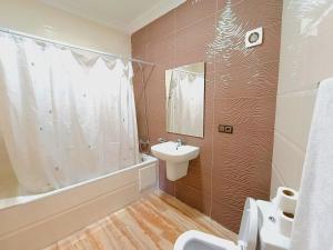 a bathroom with a sink and a toilet and a tub at Apartment chakira family only in Tangier +39 photos