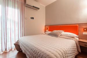 A bed or beds in a room at B&B Airone Cervia - Camere e Appartamenti