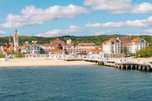 a view of a beach with a pier and buildings at Sheraton Sopot Hotel in Sopot +116 photos