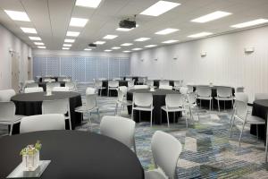 a large room with tables and chairs in it at SpringHill Suites by Marriott Wichita Airport in Wichita +18 photos