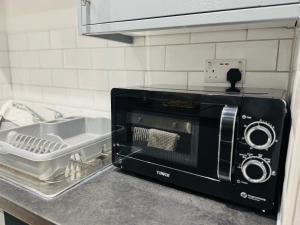 a toaster oven sitting on a counter in a kitchen at Modern 1 bedroom house in Lincolnshire