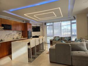 uma cozinha e sala de estar com um sofá e um bar em Horizonte Mágico full suite em Cuenca