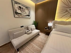a hotel room with a couch and a bed at الملقا جاكوزي لوفت Al Malqa Jacuzzi Loft in Riyadh