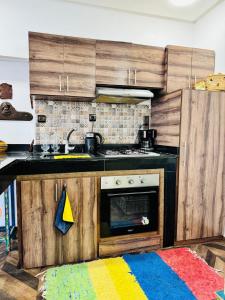 a kitchen with a stove and a kitchen rug at Center House Rabat in Rabat