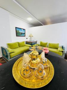 a living room with a table with glasses and a couch at Center House Rabat in Rabat +25 photos