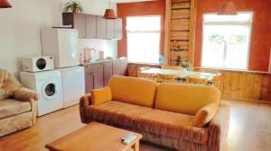 a living room with a couch and a table at Aisa Beach Area Holiday Home in Pärnu