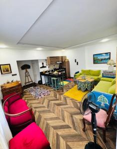 a living room with a couch and tables and chairs at Center House Rabat in Rabat