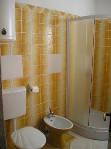 a bathroom with a shower and a toilet and a sink at Apartment Any in Selce