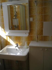 a bathroom with a sink and a mirror at Apartment Any in Selce