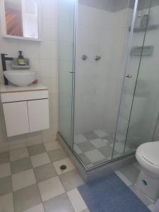 a bathroom with a shower and a toilet and a sink at Excellent Studio Apartment in Zona Rosa Milan in Manizales +1 photo