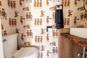 a bathroom with a toilet and a wallpaper with robots at Beech Mountain Escape with Views in Beech Mountain +50 photos