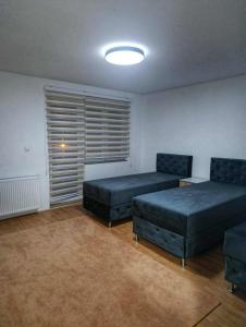 a living room with two beds and a window at Mujagin Han in Srebrenica