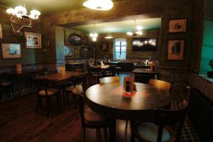 a restaurant with tables and chairs in a room at Pepin Stay in Topoľčany