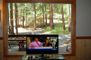 a flat screen tv sitting in a window at Ox Yoke in North Wawona +13 photos