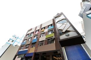 a building with many different colored windows at Hotel O Landlord in Rohtak