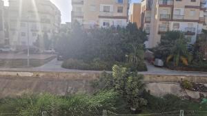 a view of a street with buildings and trees at Appart hôtel tanger in Tangier