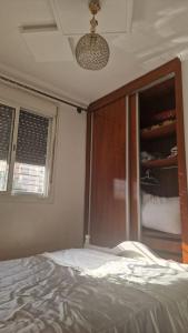 a bedroom with a bed and a glass closet at Appart hôtel tanger in Tangier
