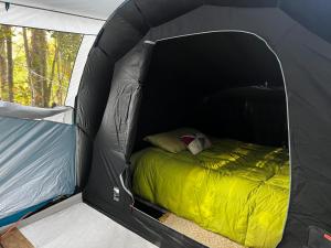 a black tent with a bed in it at Ko Glamping in Valdivia