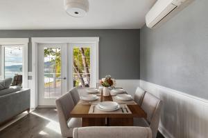 a dining room with a wooden table and chairs at Hood Canal Escape- upscale meets the rocky shores! in Belfair