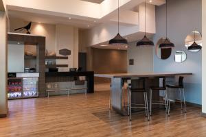 a kitchen with a counter and a bar with stools at Hampton by Hilton Cartagena in Cartagena de Indias +44 photos