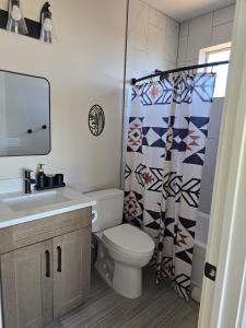 a bathroom with a toilet and a sink and a shower curtain at Canyon Casita Near Pages Natural Wonders in Page