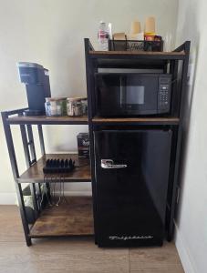 a black microwave oven sitting on a shelf at Canyon Casita Near Pages Natural Wonders in Page