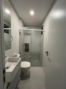 a bathroom with a shower and a toilet and a sink at Apto a 200mts do mar Meia Praia - Itapema in Itapema