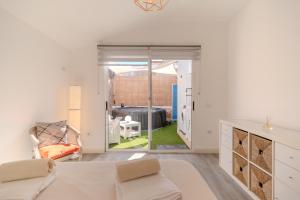 a white living room with a couch and a chair at Villa Vinidum ,CINEMA&PRIVATE POOL&JACUZZI in Arona +63 photos