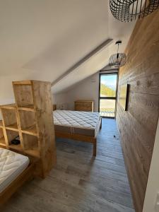 a bedroom with two beds and a window at chalet Des Cimes de Risoul in Risoul