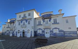 a large white building with blue tiles on it at J.M. Stay Aveiro in Aveiro