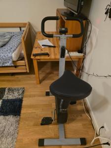 a chair in a room with a table and a bed at University House in Örebro