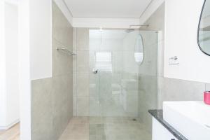 a bathroom with a glass shower with a sink at Modern 2 Bed Home with Solar & Braai Langebaan in Langebaan +41 photos