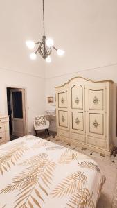 a bedroom with a large bed and a desk at Private Home with Sunset and Gallipoli Views in Parabita