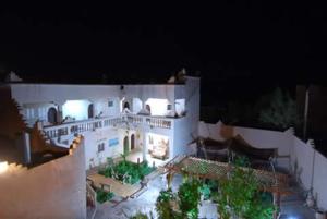 an aerial view of a large white house at night at Dar dmana chez l'habitant in Skoura