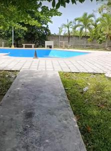 a large swimming pool in a park with trees at Villa en higuerote in Higuerote