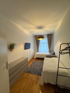 a bedroom with two beds and a tv in it at Gemütliche 2-Raum-Wohnung in Leipzig +3 photos