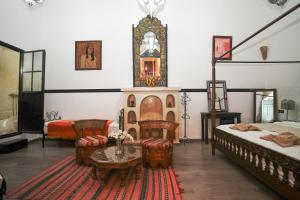 a room with two beds and a table and a room with two beds at Dar JOMANA in Marrakech