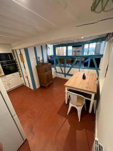 a view of a kitchen with a table and a dining room at Chez Fil'O in La Bouille