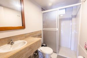 a bathroom with a shower and a sink and a toilet at Hotel Bania travels in Guatapé +50 photos