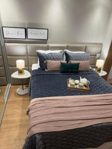 a bedroom with a large bed with a tray on it at Estúdio Lumière Moema in Sao Paulo